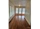 Bright living room featuring hardwood floors, wainscotting, and large windows at 273 E Main Ave, Taylorsville, NC 28681