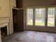 Dilapidated living room featuring a fireplace and a window at 273 E Main Ave, Taylorsville, NC 28681