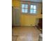 A shot of a room needing renovations with yellow walls and a textured ceiling at 273 E Main Ave, Taylorsville, NC 28681
