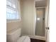 White tile in the shower and toilet area at 3316 Mckee Rd, Charlotte, NC 28270