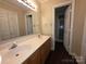 Bathroom with double sink vanity, large mirror and walk-in shower at 3316 Mckee Rd, Charlotte, NC 28270