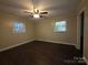 The bedroom has two windows letting in natural light and a ceiling fan at 3316 Mckee Rd, Charlotte, NC 28270