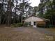 Home exterior has brick and siding with gravel driveway at 3316 Mckee Rd, Charlotte, NC 28270