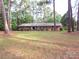 Traditional brick home on a large lot with mature trees and a spacious front yard in a quiet neighborhood at 3316 Mckee Rd, Charlotte, NC 28270