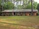 Charming brick ranch home with a well-manicured lawn and mature trees, offering great curb appeal at 3316 Mckee Rd, Charlotte, NC 28270
