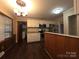 Eat-in kitchen with granite countertops, modern appliances, white cabinets, and wood-look floors at 3316 Mckee Rd, Charlotte, NC 28270