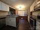 Well-appointed kitchen featuring white cabinetry, stainless steel appliances, and stylish wood-look flooring at 3316 Mckee Rd, Charlotte, NC 28270