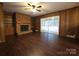 Spacious living room features a brick fireplace, built-in shelves, wood paneling and large windows at 3316 Mckee Rd, Charlotte, NC 28270