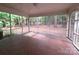 Enclosed screened porch with mosaic tiled floor surrounded by a lush green space at 3316 Mckee Rd, Charlotte, NC 28270