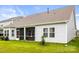 Beautiful backyard view, featuring a screened-in porch with a lush green lawn and mature trees at 4046 Starfire Ln, Rock Hill, SC 29732