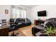 Comfortable living room features a black leather couch, hardwood floors, and bright natural light at 4046 Starfire Ln, Rock Hill, SC 29732