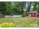 Spacious backyard showcasing the home's exterior, well-maintained lawn, and privacy fencing at 4235 Howie Cir, Charlotte, NC 28205