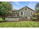 Charming home featuring a wooden deck, green lawn, and lush landscaping, perfect for outdoor entertaining at 4235 Howie Cir, Charlotte, NC 28205