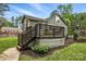 Inviting backyard with a wooden deck, complemented by well-maintained lawn and garden, ideal for relaxation at 4235 Howie Cir, Charlotte, NC 28205