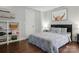 Stylish bedroom featuring a queen bed, dark wood floors and decorative shelving at 4235 Howie Cir, Charlotte, NC 28205