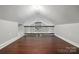 A finished bonus room with hardwood floors and a dark-stained railing at 4235 Howie Cir, Charlotte, NC 28205