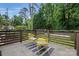 Relaxing deck with stylish yellow chairs and a striped rug, offering a cozy outdoor seating area with privacy fence at 4235 Howie Cir, Charlotte, NC 28205