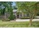 Charming stone home with a well-manicured front yard and inviting covered porch at 4235 Howie Cir, Charlotte, NC 28205