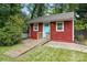 Red exterior with a light blue door and wheelchair ramp provides an accessible entrance to the unit at 4235 Howie Cir, Charlotte, NC 28205