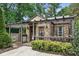 Close up of a stone home with a covered porch, pergola and inviting entrance at 4235 Howie Cir, Charlotte, NC 28205