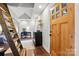 Bright foyer with hardwood floors, a staircase, desk and an exterior door at 4235 Howie Cir, Charlotte, NC 28205