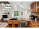 Kitchen featuring wood counters, stainless steel dishwasher, and an eat-in counter at 4235 Howie Cir, Charlotte, NC 28205