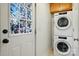 Compact laundry room with stacked washer/dryer and a decorative stained-glass door at 4235 Howie Cir, Charlotte, NC 28205