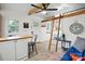 Open-concept living area with wood-look flooring, ladder access to loft area, and a cozy seating arrangement at 4235 Howie Cir, Charlotte, NC 28205