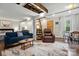 Open-concept living room featuring hardwood floors, comfortable seating, and ample natural light at 4235 Howie Cir, Charlotte, NC 28205