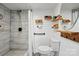 Tiled shower with rainfall shower head and built-in shelves in a modern bathroom at 4235 Howie Cir, Charlotte, NC 28205