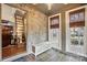 Sunroom with stone accent wall, tile floors and a rustic ladder to an upstairs space at 4235 Howie Cir, Charlotte, NC 28205