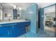 Vibrant bathroom with blue mosaic tiles, sleek vanity, and walk-in shower for a modern aesthetic at 447 Merwick Cir, Charlotte, NC 28211