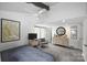 Bright bedroom featuring ceiling fan, gray carpet, and stylish chair for a relaxing space at 447 Merwick Cir, Charlotte, NC 28211