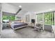 Cozy bedroom with neutral tones, ceiling fan, and an abundance of natural light from large windows at 447 Merwick Cir, Charlotte, NC 28211