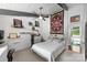 Comfortable bedroom featuring a queen bed and custom shelves, perfect for storage and display at 447 Merwick Cir, Charlotte, NC 28211