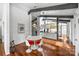 Open dining area with modern white table and chairs, hardwood floors, and adjacent to the kitchen at 447 Merwick Cir, Charlotte, NC 28211