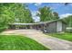 Exterior of home featuring manicured lawn, carport and well-maintained landscaping at 447 Merwick Cir, Charlotte, NC 28211