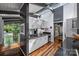 Modern kitchen boasts stainless appliances, white cabinets, and hardwood floors with natural light at 447 Merwick Cir, Charlotte, NC 28211