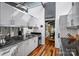 Modern kitchen boasts stainless appliances, white cabinets, and hardwood floors with natural light at 447 Merwick Cir, Charlotte, NC 28211