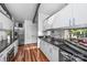 Modern kitchen features sleek white cabinets, dark countertops, and stainless steel appliances at 447 Merwick Cir, Charlotte, NC 28211