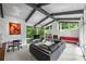 Bright living room boasts large windows, vaulted ceilings with exposed beams, and a cozy fireplace at 447 Merwick Cir, Charlotte, NC 28211