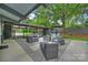 Cozy patio featuring outdoor seating and mature trees with an outdoor umbrella for shade at 447 Merwick Cir, Charlotte, NC 28211