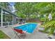 Pool featuring clear blue water, lounge chairs, a home, and mature landscaping at 447 Merwick Cir, Charlotte, NC 28211