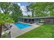 Aerial view of a backyard pool with outdoor furniture and mature landscaping at 447 Merwick Cir, Charlotte, NC 28211