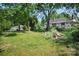 View of the home's backyard, full of trees, shrubbery and potential to make it your own at 514 S Martin St, Shelby, NC 28150