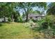 View of the home's backyard, full of trees, shrubbery and potential to make it your own at 514 S Martin St, Shelby, NC 28150