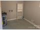 A partially finished basement with laundry connections and storage shelves at 520 Crestview Dr, Albemarle, NC 28001