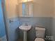 A cozy bathroom features blue tile, and a pedestal sink at 520 Crestview Dr, Albemarle, NC 28001