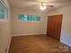 This bedroom features wood-look floors, a large window, and a closet at 520 Crestview Dr, Albemarle, NC 28001