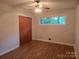 This bedroom features wood-look floors, a ceiling fan, a window, and a closet at 520 Crestview Dr, Albemarle, NC 28001